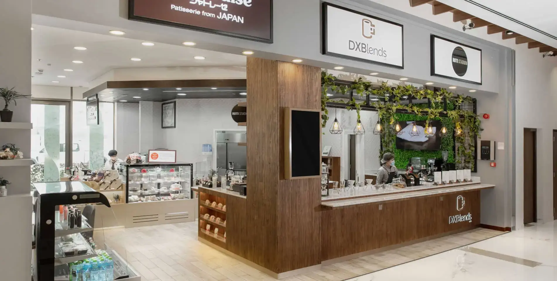 Retail cafe interior fit-out with timber counter and planted display wall