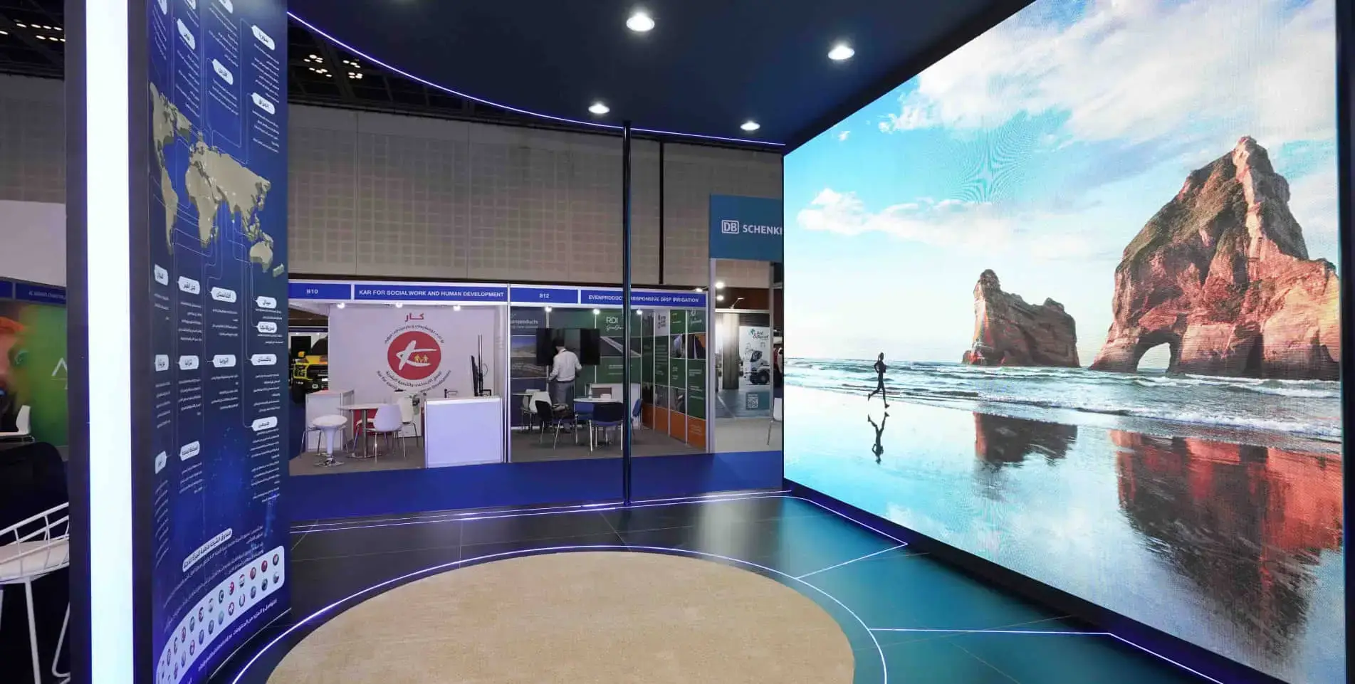 Exhibition stand with large curved LED video wall and dark blue flooring