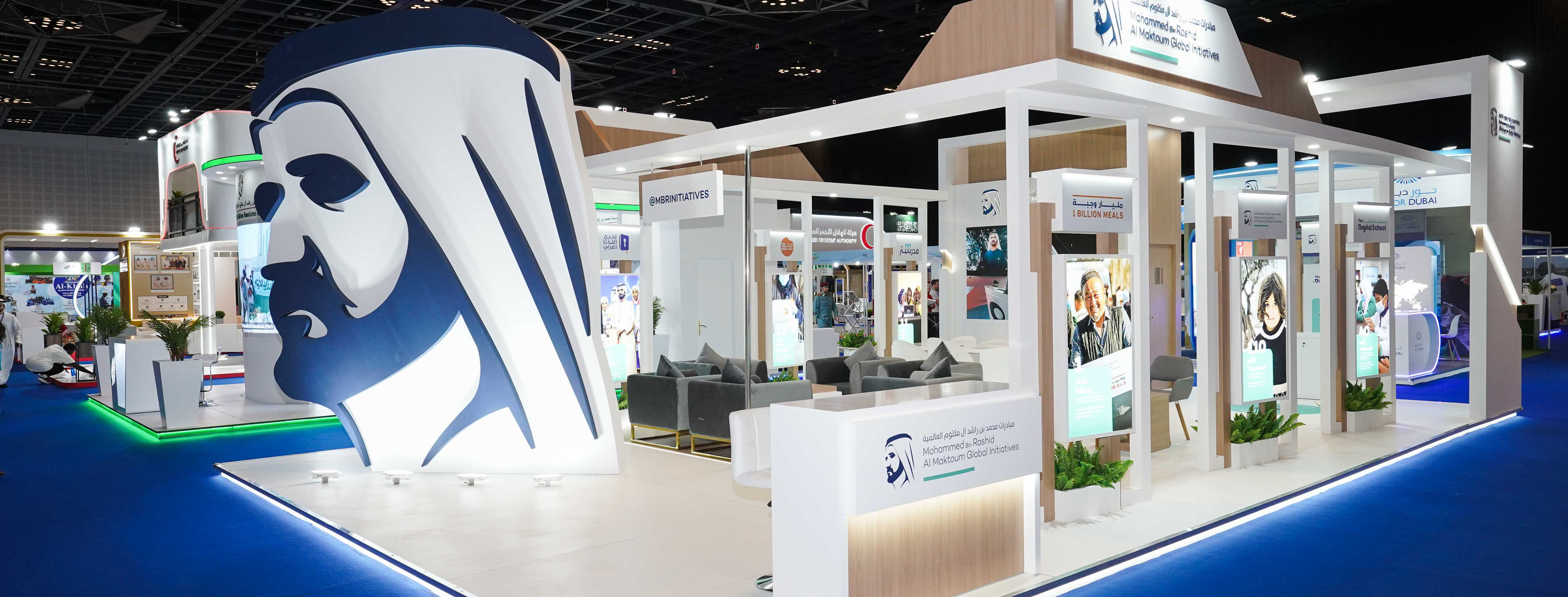Exhibition stand with oversized Emirati portrait graphic and blue perimeter lighting