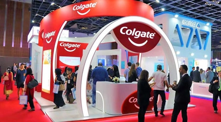 Colgate exhibition stand with red arched entrance at a Dubai dental exhibition