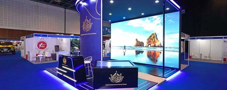 Luxury brand stand with full-height LED video wall and deep blue lighting
