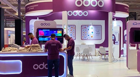 Odoo software exhibition stand in purple with demo terminals and lounge seating