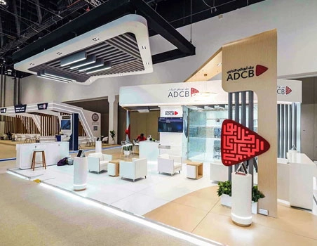 ADCB banking stand with sculptural red artwork and glazed display cases