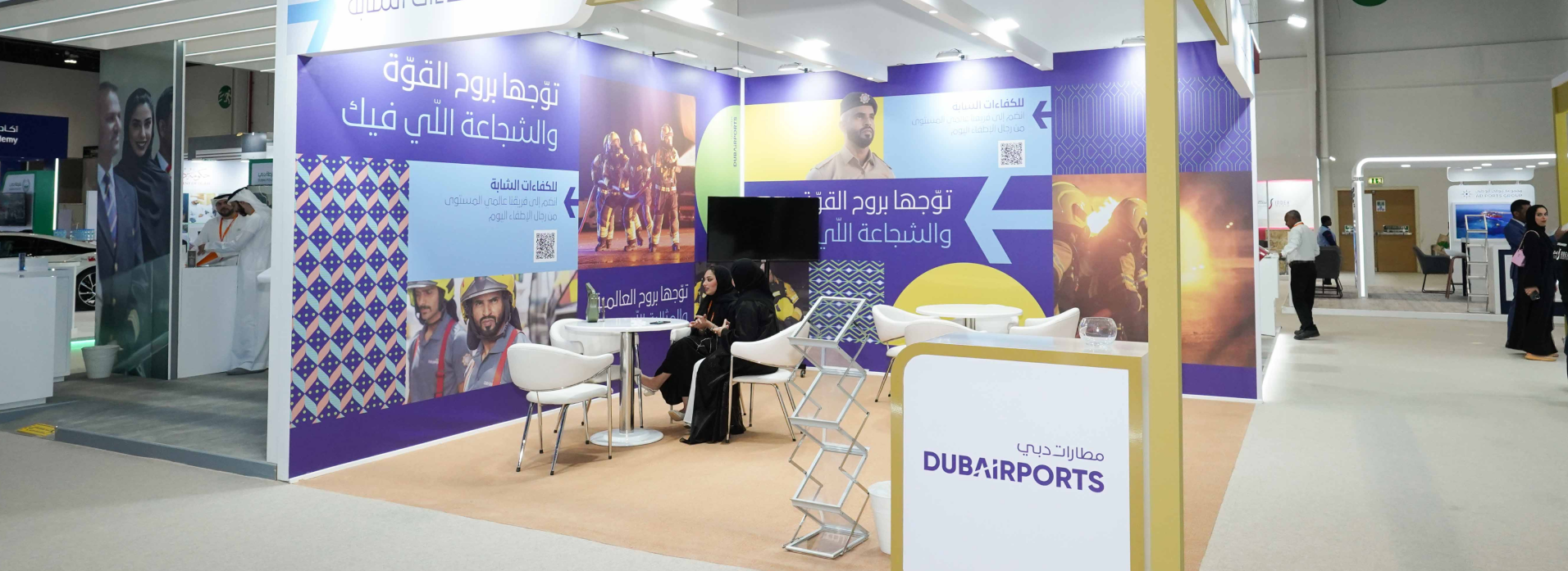Dubai Sports exhibition stand with purple graphics and meeting area